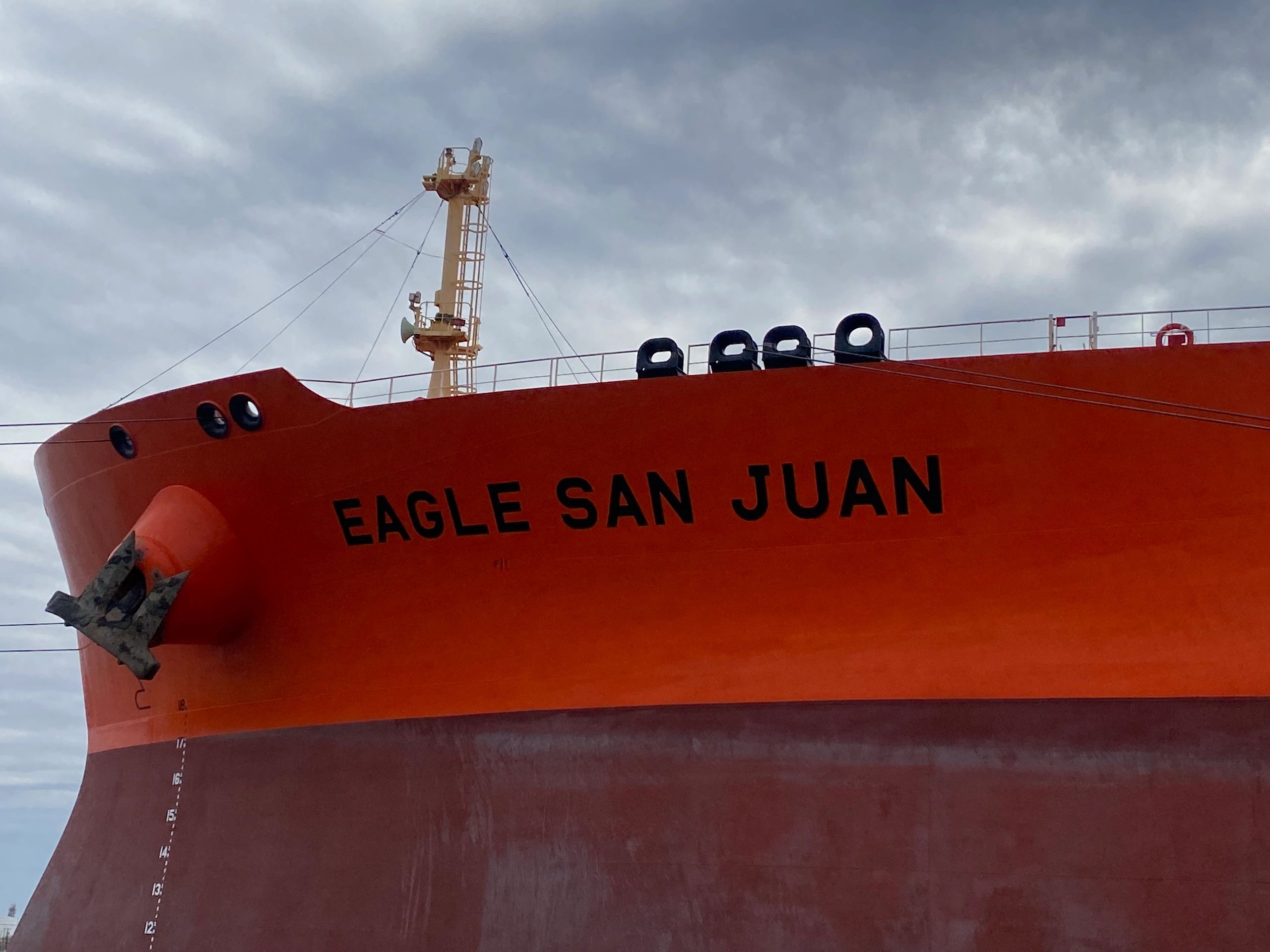 Bow of the orange tanker ship Eagle San Juan approaching a marine terminal